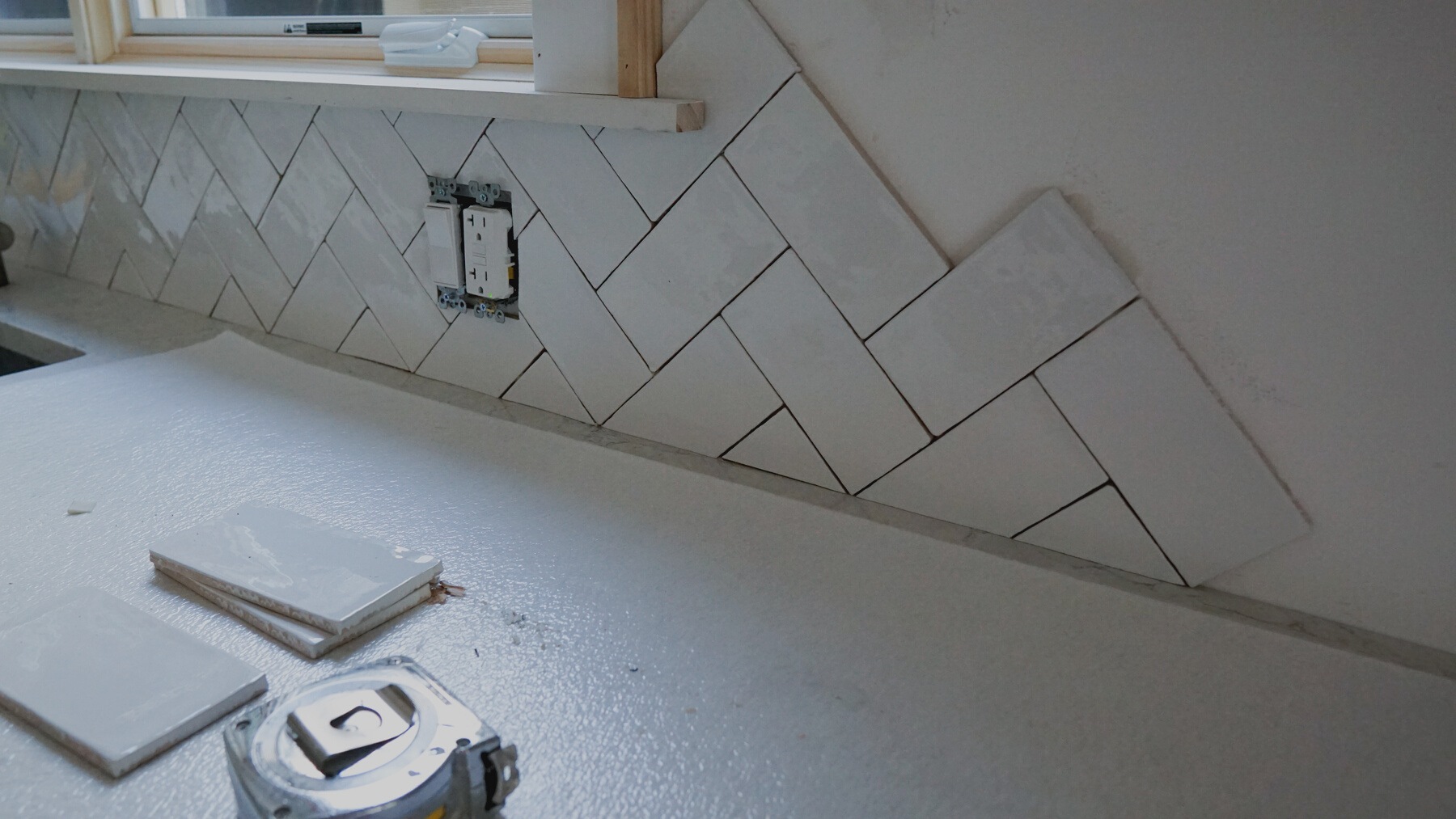 Home improvement - installing a white kitchen tile backsplash